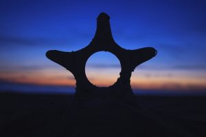夕焼けの空と地平線とヒトデの飾りが写った写真の画像